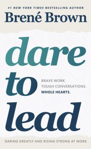 The cover of Brene Brown's book Dare to Lead. A simple cover with blue writing on a white and grey background.