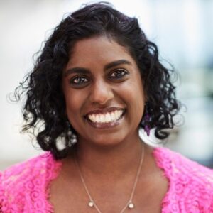 Professional headshot photograph of Malini Raj.